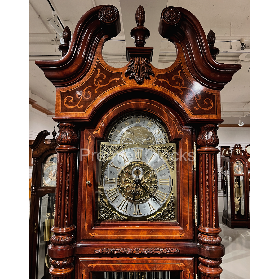 https://www.premierclocks.com/cdn/shop/files/Howard_Miller_J.H._Miller_II_Grandfather_Clock_611031_real_photo_split_pediment_Premier_Clocks.png?v=1704683463